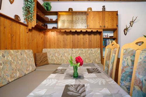 a dining room with a table with a vase of flowers at Ferienhaus Carpin in Carpin