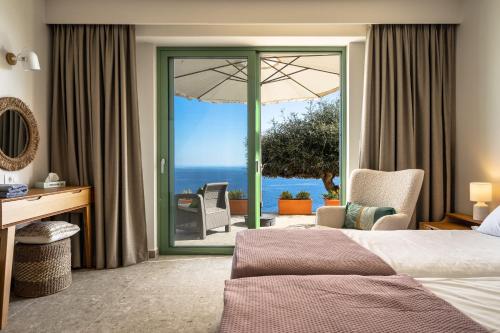 a hotel room with a bed and a view of the ocean at Joy Breeze in Kefallonia
