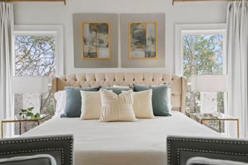 a bedroom with a large bed with white and blue pillows at Red Bluff Cottage in Montgomery