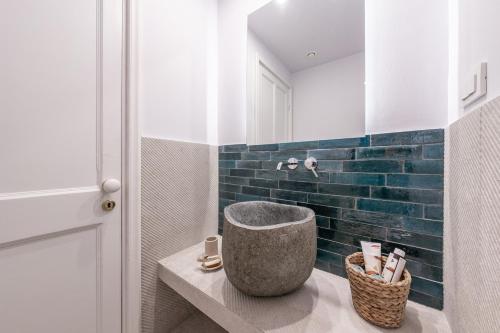 a bathroom with a stone tub sitting on a counter at The Olive Yard Corfu Sidari in Karousádes