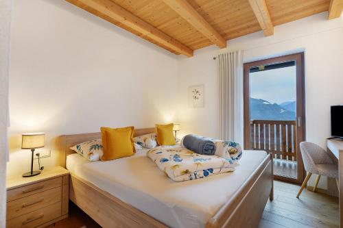 a bedroom with a bed with a view of a mountain at Löchlerhof in Ritten