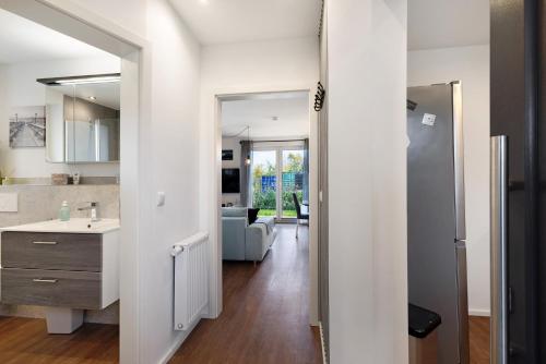 a kitchen and living room with a sink and a counter at Küsten-Bude in Elmenhorst