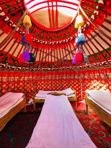 a bedroom with two beds in a yurt at Azamat Nomad Camp in Song-Kul