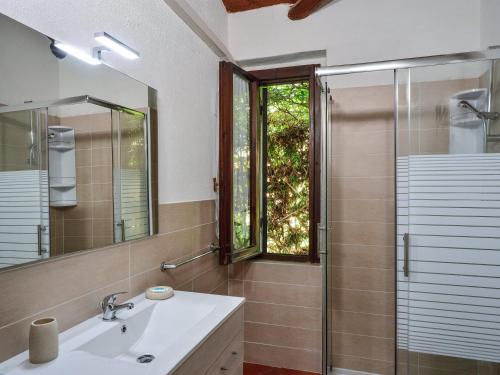 a bathroom with a sink and a glass shower at Villa Romana in Costa Rei