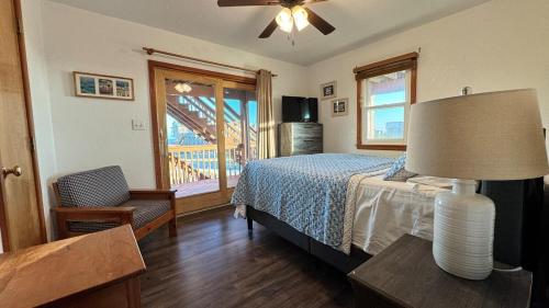 a bedroom with a bed and a table with a lamp at Carolina Breeze in Rodanthe