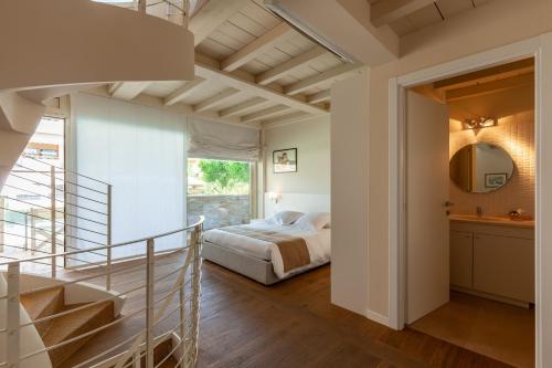 a bedroom with a staircase leading to a bed at Appartamento Bacco in Lido di Camaiore