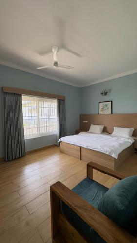 a large bedroom with a large bed and a window at Yak villa in Kushālnagar