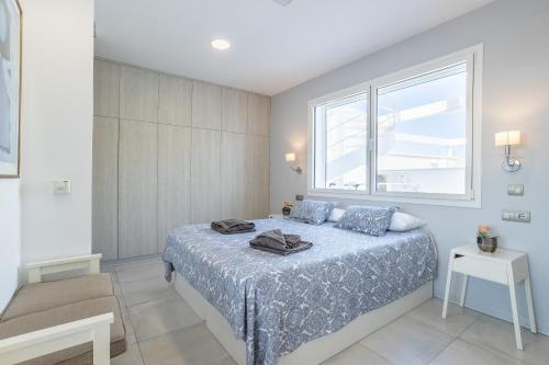 a bedroom with a bed and a large window at Sai Gayatri in Nerja