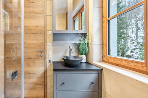 a bathroom with a sink and a window at Goodlife Top 1 in Saalbach-Hinterglemm