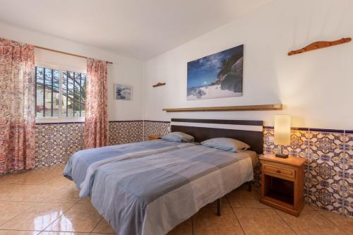 a bedroom with a bed and a window at Casa Marron in Costa Calma