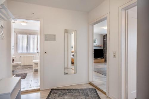a hallway with white walls and a mirror at Ferienwohnung Dachtler in Hinterzarten