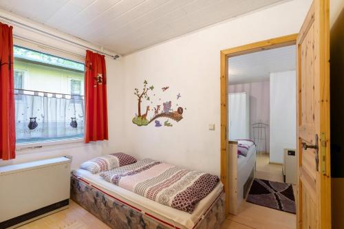 a bedroom with a bed and a window at Ferienbungalow 2 in Boitzenburg in Boitzenburg