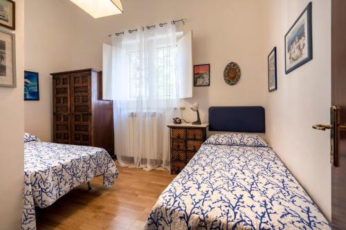 a bedroom with two beds and a window at Villa Massa in Polignano a Mare