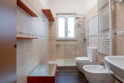 a bathroom with a toilet and a sink at Villa Massa in Polignano a Mare