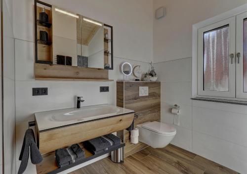 a bathroom with a sink and a toilet at Luxus Chalet Landhaus Rachelblick in Eppenschlag