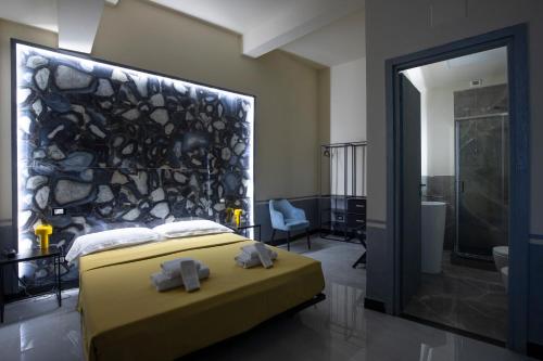 a bedroom with a bed with two towels on it at Hotel Torre Orefici in Genoa