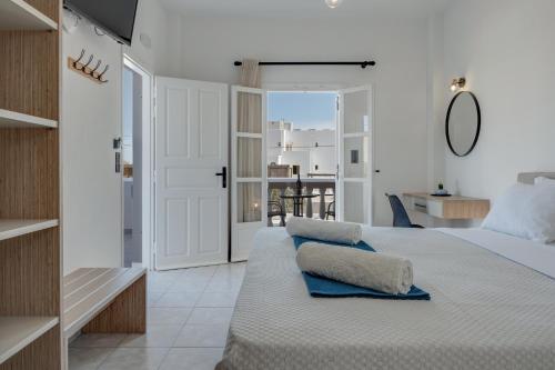 a bedroom with a bed with a view of a balcony at 08 Double room Perivolos beach in Santorini