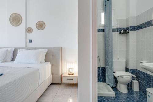 a bedroom with a bed and a shower and a toilet at 08 Double room Perivolos beach in Santorini