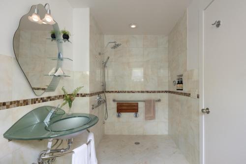 a bathroom with a glass sink and a shower at The Trail in Adams - Berkshires' Art Hotel in Adams