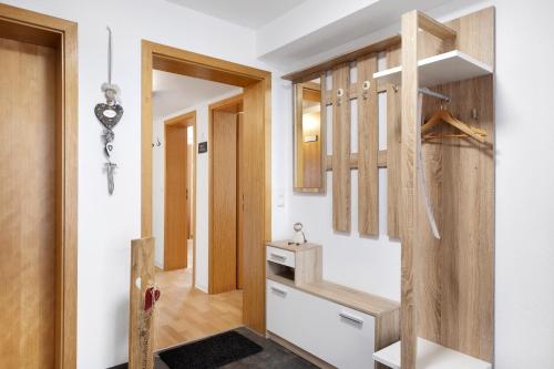a small kitchen with wooden cabinets and a sink at Ferienwohnung Windradblick in Schonach