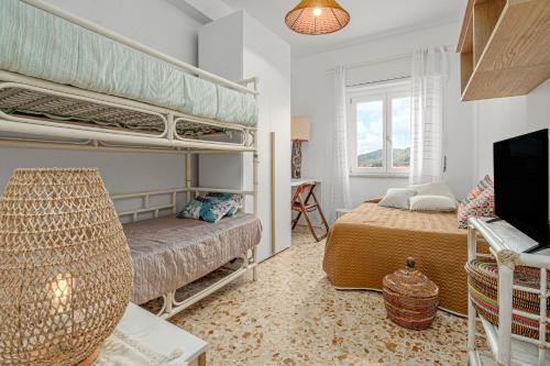 a bedroom with two bunk beds and a tv at Appartamento del corso in Olbia