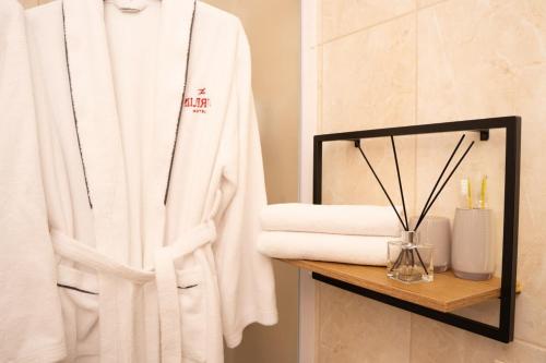 a white robe on a shelf in a bathroom at Шляпа in Dnipro