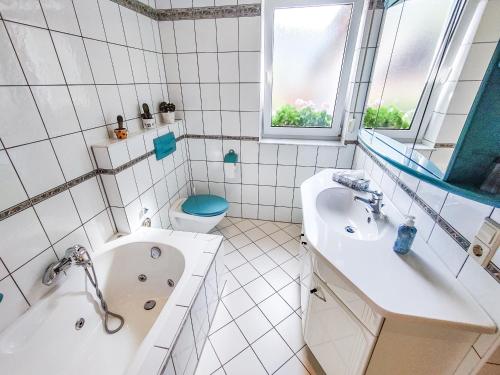 a bathroom with a tub and a sink and a toilet at Ferienwohnung Ella, 95qm, Terrasse in Todtnau