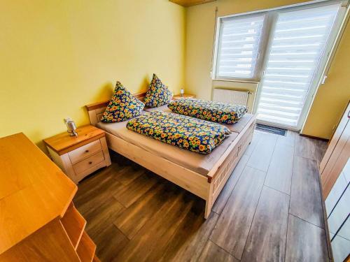 a room with a couch with pillows and a window at Ferienwohnung Ella, 95qm, Terrasse in Todtnau