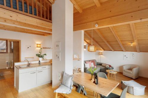 a kitchen and living room with a wooden ceiling at Löchlerhof in Ritten