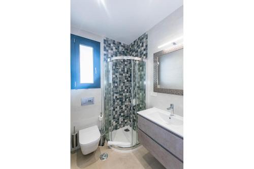 a bathroom with a sink toilet and a shower at Spacious apartment in Cómpeta in Cómpeta