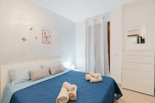 a bedroom with a blue bed with towels on it at Villetta Marettimo Cornino in Custonaci