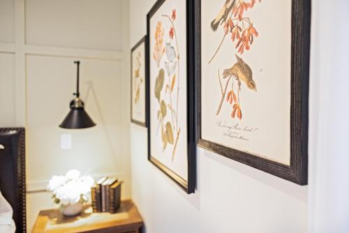 a room with framed art on the wall at Kildahl House - Boutique Farmhouse Suite #2 in West Dundee