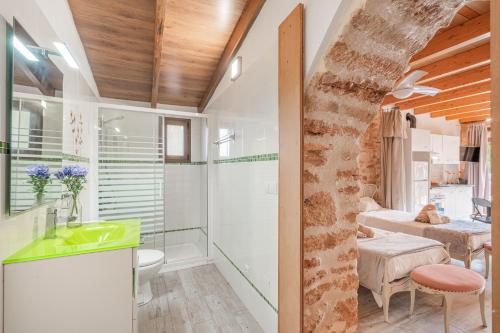 a bathroom with a glass shower and a sink at Can Garraseca in Llucmajor