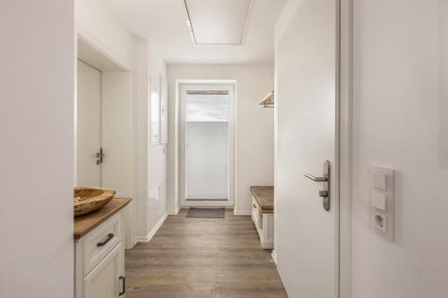 a bathroom with a hallway with a sink and a mirror at Fewo Landblick Geiseltal in Braunsbedra