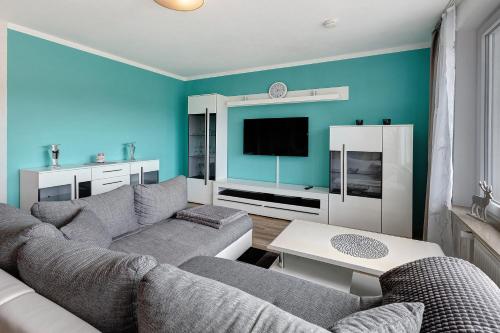 a living room with a couch and a tv at Sonnenblick in Lenzkirch