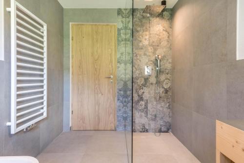 a shower with a glass door in a bathroom at Apartement Franzl in San Vigilio Di Marebbe