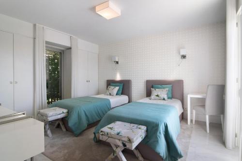 a hospital room with two beds and a window at Sweet Home Albufeira in Albufeira