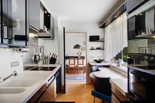 a kitchen with white countertops and a dining room at Haus Gutschi in Imst