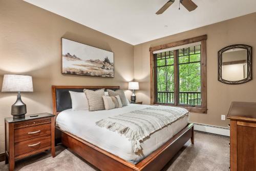 a bedroom with a large bed and a window at Luxe Breck Escape - 2BR & 2BA with Pool, Hot Tubs & Walk to Downtown in Breckenridge