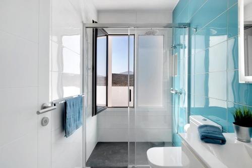 a bathroom with a glass shower and a sink at Coral 5 in La Santa