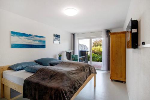 a bedroom with a large bed with blue pillows at Easy Living in Tettnang