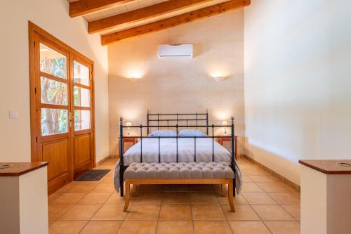 a bedroom with a bed in a room with a window at Finca Biniali in Sencelles