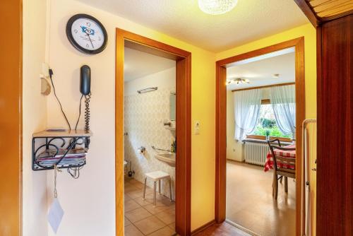 a room with a hallway with a clock on the wall at Bergblick in Forbach