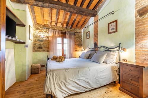 a bedroom with a bed and a brick wall at Beb Pulcino Nero Scrofiano in Scrofiano