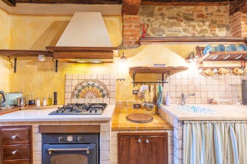 a kitchen with a stove and a sink at Beb Pulcino Nero Scrofiano in Scrofiano