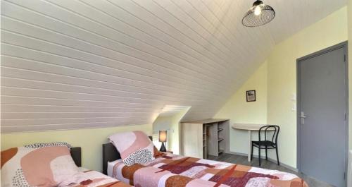 a bedroom with two beds and a white ceiling at Ô Pré des Fleurs in Amanlis