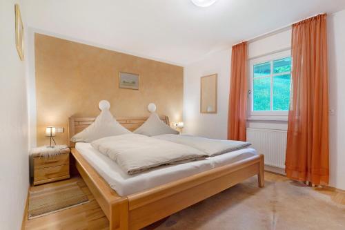 a bedroom with a large bed and a window at Landeckhof in Oberwolfach