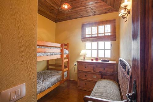 a bedroom with two bunk beds and a window at Tmg Casa La Chocita in Los Realejos