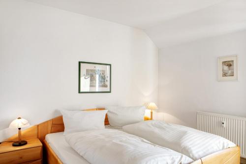 a bedroom with two beds with white sheets at Ferienwohnung Tannenblick 7-4 in Oberhof