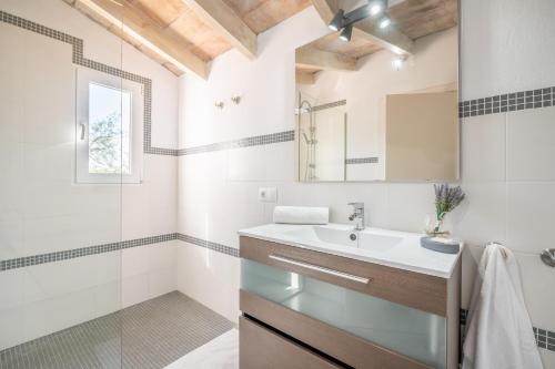 a bathroom with a sink and a mirror at Ses Oliveres in Pollença